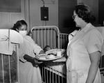 (29166) Female Food Service Employees Tending to Patient, 1952 (29166) Female Food Service Employees Tending to Patient, 1952