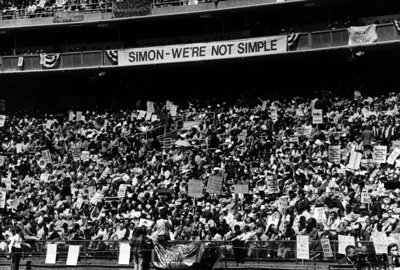 (29327) "Simon - We're Not Simple," Rally for Jobs Now, Robert F. Kennedy Stadium, Washington, D.C., 1975 (29327) "Simon - We're Not Simple," Rally for Jobs Now, Robert F. Kennedy Stadium, Washington, D.C., 1975