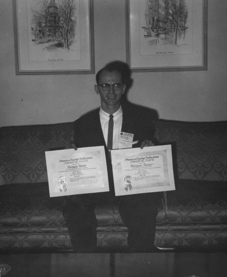 (11892) Henry Linne posing with awards (11892) Henry Linne posing with awards